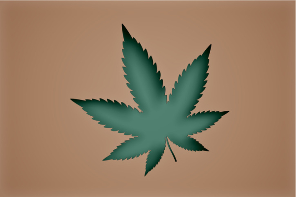 Brown background with a cutout of a green marijuana leaf in the foreground